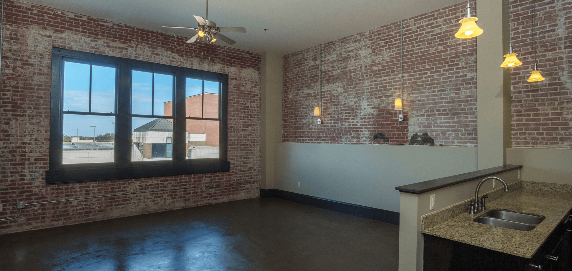 living room view of 22 Monroe apartments with large window looking out
