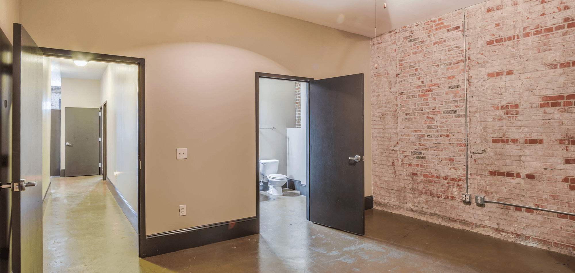 bedroom view showing attached bath and hallway in 22 Monroe apartments