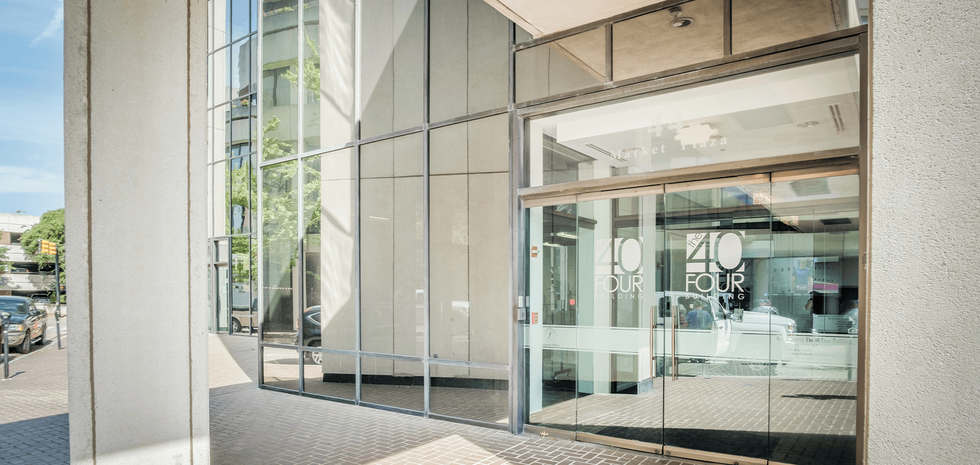 Entrance to the 40 Four Building with glass doors and mirrored windows