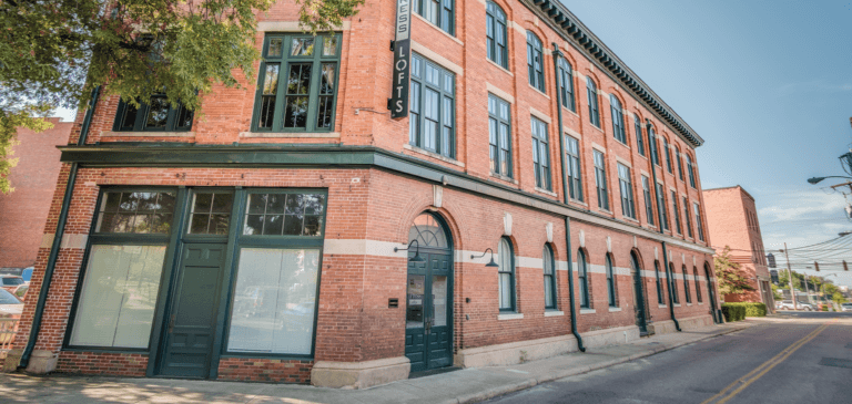 The printing press loft apartments in Montgomery AL exterior view showing red brick and arched windows