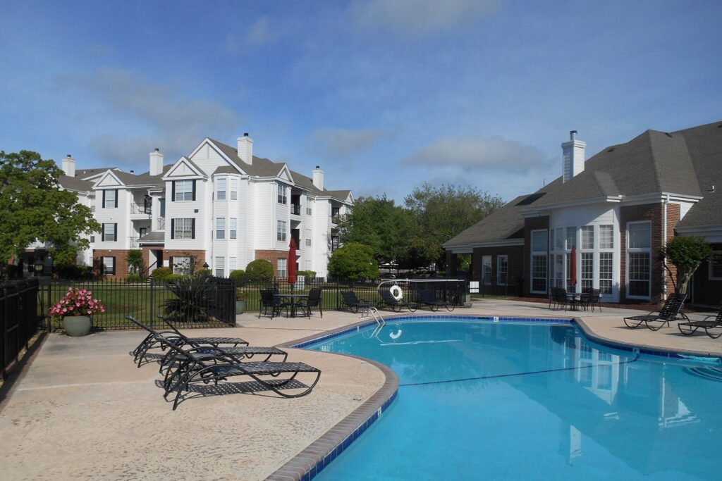 Sunny pool area with lounge chairs