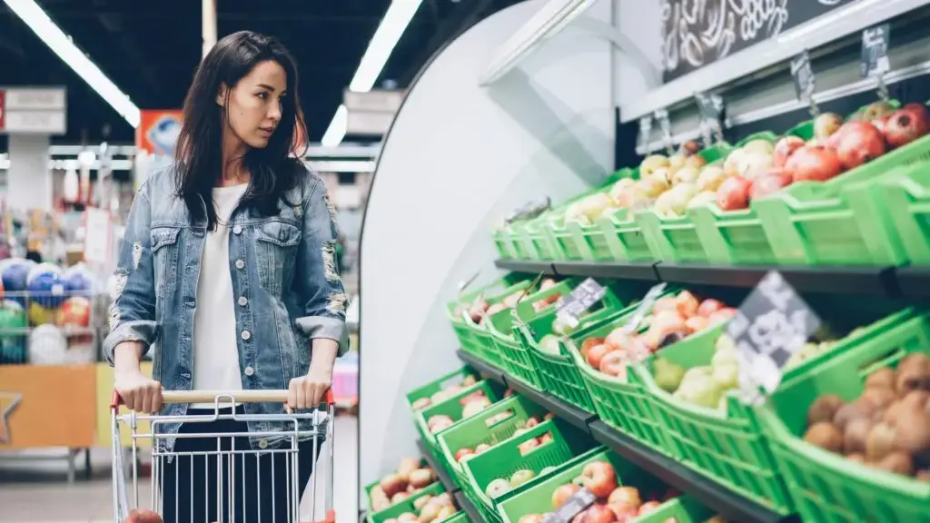 Woman Browsing food aisle stretching your grocery budget
