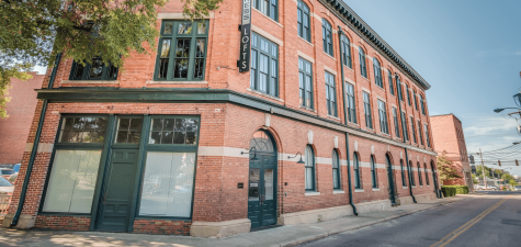 The printing press loft apartments in Montgomery AL exterior view showing red brick and arched windows